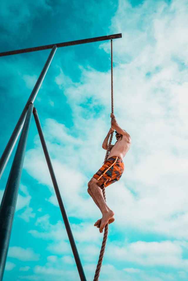 man about to climb using brown rope